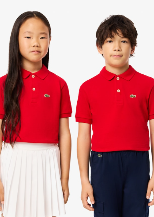 2 kids, boy and girl, wearing red Lacoste polo shirts